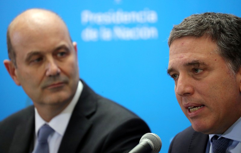 Argentina's Treasury Minister Dujovne speaks next to Argentina's Central Bank President Sturzenegger during a news conference in Buenos Aires