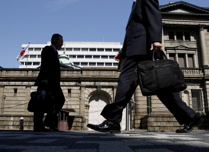 FILE PHOTO - People walk on a street in front of the Bank of Japan headquarters in Tokyo