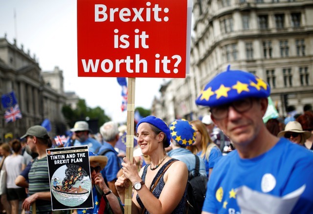 A woman holds a placard as she joins EU supporters, calling on the government to give Britons a vote on the final Brexit deal, participating in the 'People's Vote' march in central London