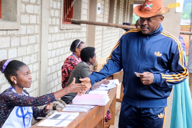 Burundi President Pierre Nkurunziza is registered by an electoral official before casting his ballot at a polling centre during the constitutional amendment referendum at School Ecofo de Buye in Mwumba commune in Ngozi province