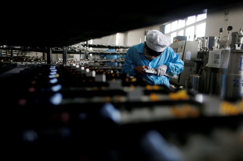 FILE PHOTO: Labourer works inside an electronics factory in Qingdao