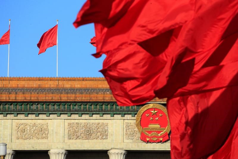 FILE PHOTO: Red flags flutter outside the Great Hall of the People before the second plenary session of the CPPCC in Beijing