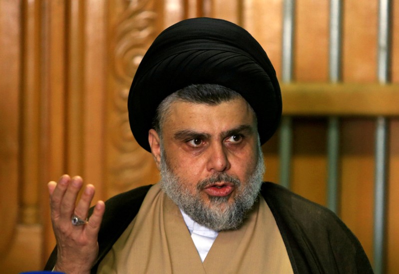 FILE PHOTO: Iraqi Shi'ite cleric Moqtada al-Sadr speaks during a news conference with Iraqi politician Ammar al-Hakim, leader of the Hikma Current, in Najaf