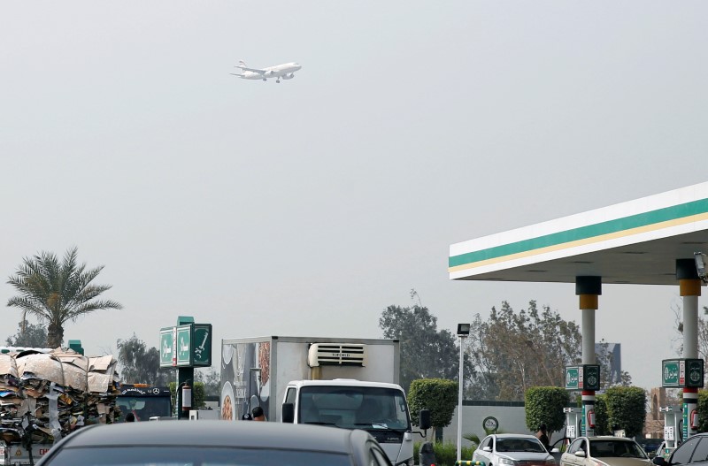 Consumers purchase fuel at a petrol station near Cairo Airport
