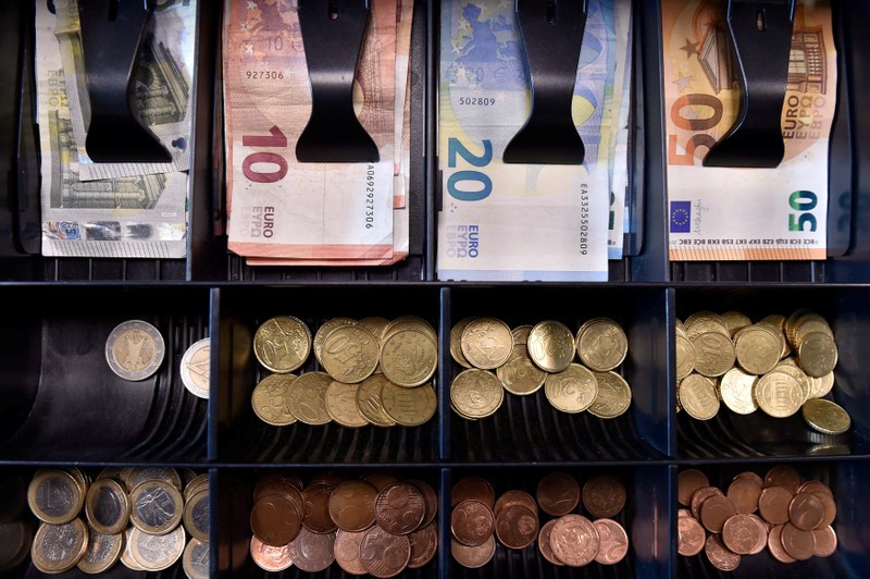 FILE PHOTO: Euro banknotes and coins are displayed in a shop in Brussels