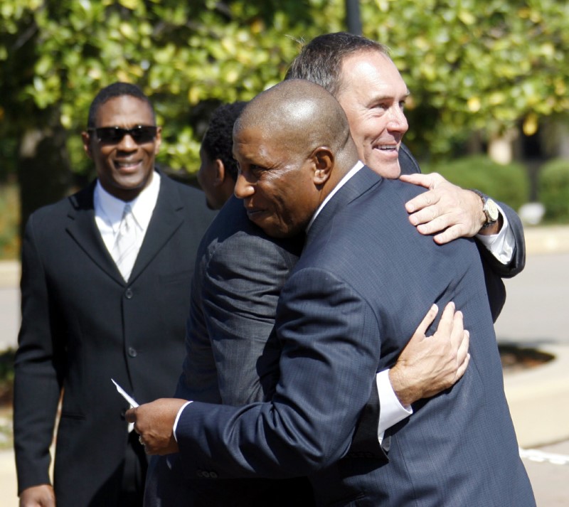 Former San Francisco 49ers great, wide receiver Clark greets former teammate, running back Tyler, before the memorial for former NFL football coach Walsh at Stanford Memorial Church in Stanford