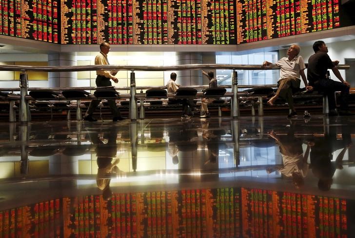Investors monitor share market prices in Kuala Lumpur, Malaysia