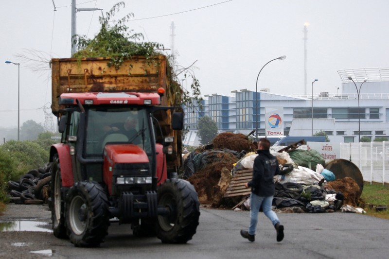 French farmers, members of the FNSEA, the country's largest farmers' union, block with their tractors the access of the French oil giant Total refinery in Donges