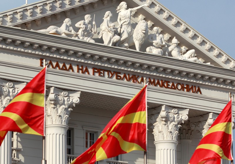 National Macedonian flags flutter in front of the government building in Skopje