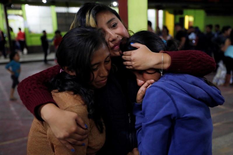 Women react inside a shelter after Fuego volcano erupted violently in San Juan Alotenango