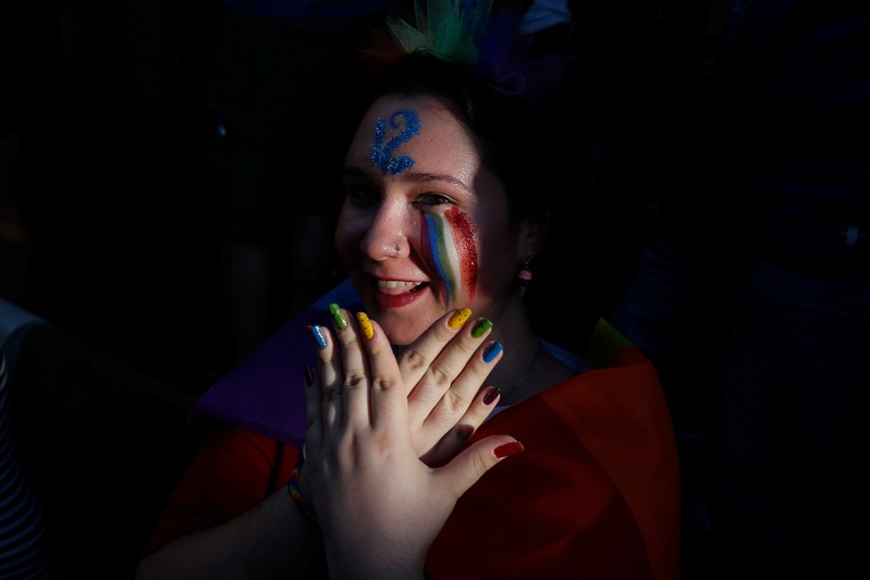 A participant poses for a picture during a gay pride parade in Athens