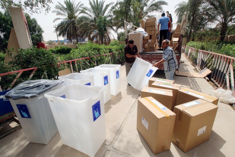 FILE PHOTO: Iraqi Independent High Electoral Commission staff members distribute ballot boxes and polling materials to polling stations in Basra