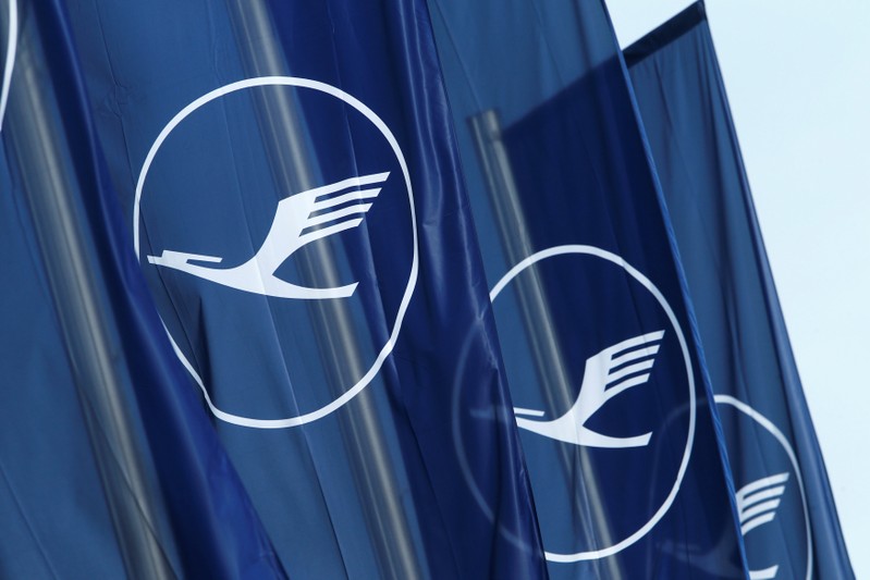 FILE PHOTO: Flags with the German airline Lufthansa sign flutter next to the office building in Frankfurt