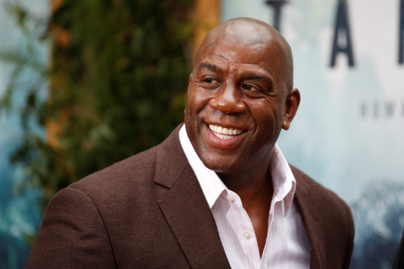 Former NBA basketball player Earvin Magic Johnson poses at the premiere of the movie 