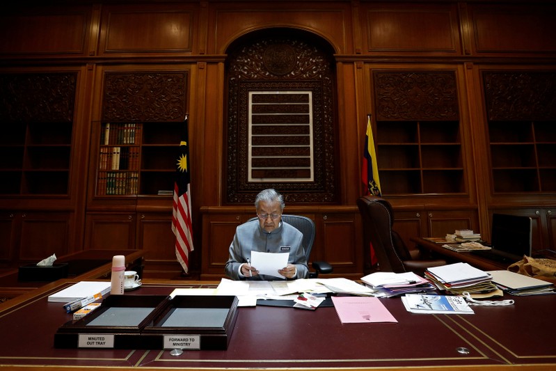 Malaysia's Prime Minister Mahathir Mohamad works at his office in Putrajaya