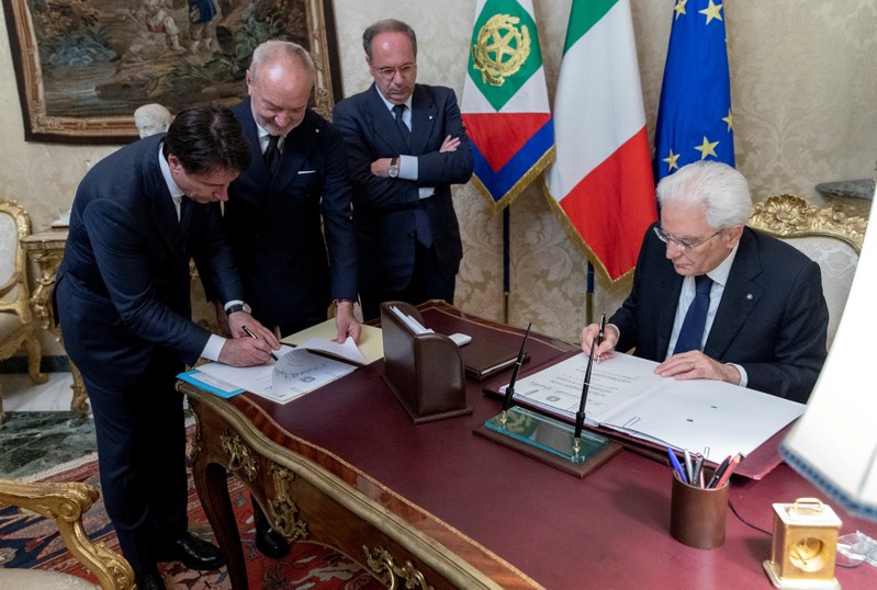 Conte and Italian President Mattarella sign documents at the Quirinal Palace in Rome