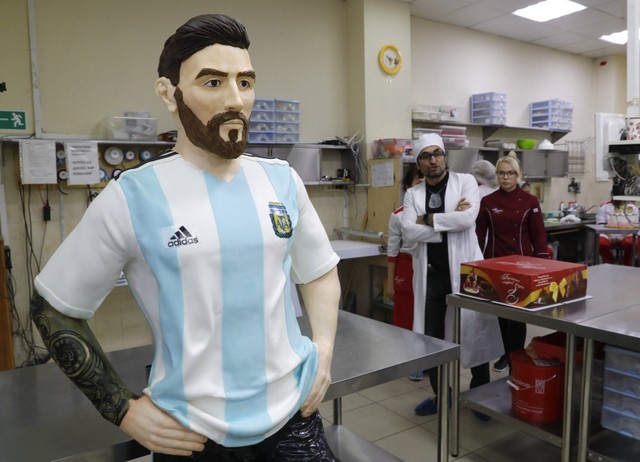Bakers prepare a life-size chocolate sculpture of Argentine soccer player Lionel Messi to top a cake for the celebration of his upcoming birthday in Moscow