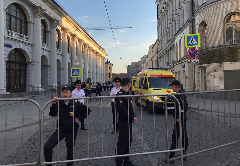 Policemen stand guard after a taxi ran into crowds of people in central Moscow