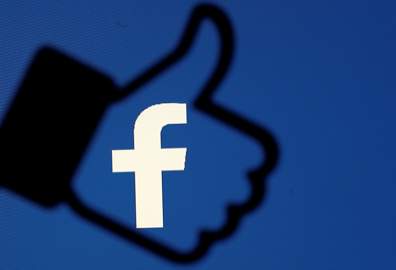 FILE PHOTO: A 3D-printed Facebook like button is seen in front of the Facebook logo, in this illustration