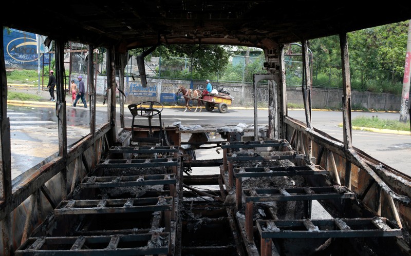 A burned bus is seen during a protest against Nicaragua's President Daniel Ortega's government at neighborhood in Managua