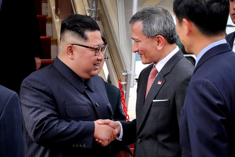 Singapore's Foreign Minister Vivian Balakrishnan welcomes North Korean leader Kim Jong Un on his arrival in Singapore