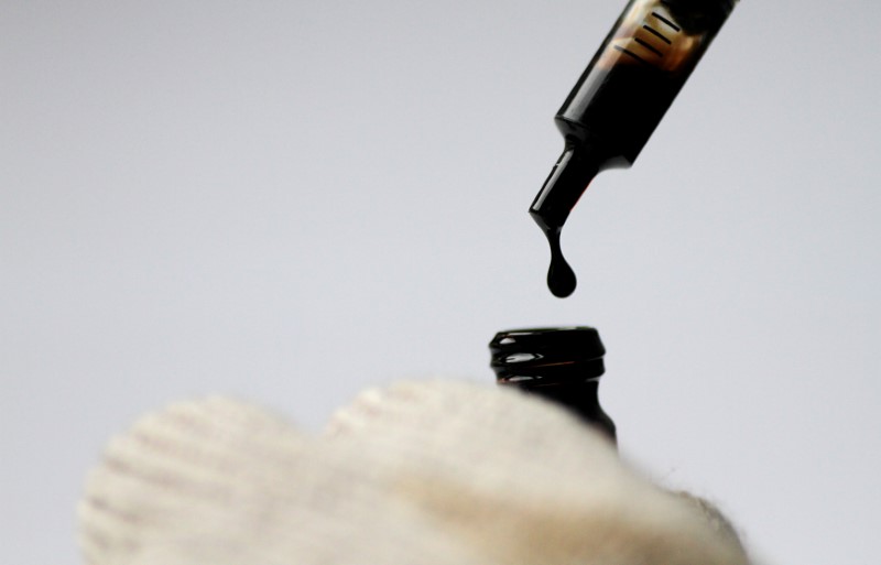 Illustration photo of crude oil being dispensed into a bottle