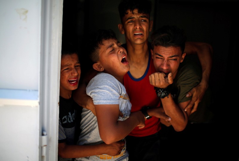 Relatives of a Palestinian, who was killed at the Israel-Gaza border, react at a hospital in Gaza City