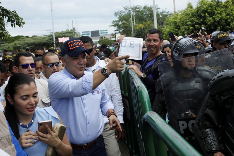 Colombian presidential candidate Ivan Duque greets supporters on the Simon Bolivar international bridge in Cucuta