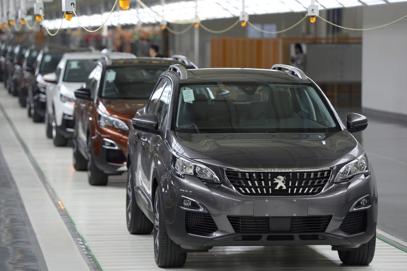 FILE PHOTO: Vehicles are seen at a Dongfeng Peugeot Citroen factory before it starts up production in Chengdu