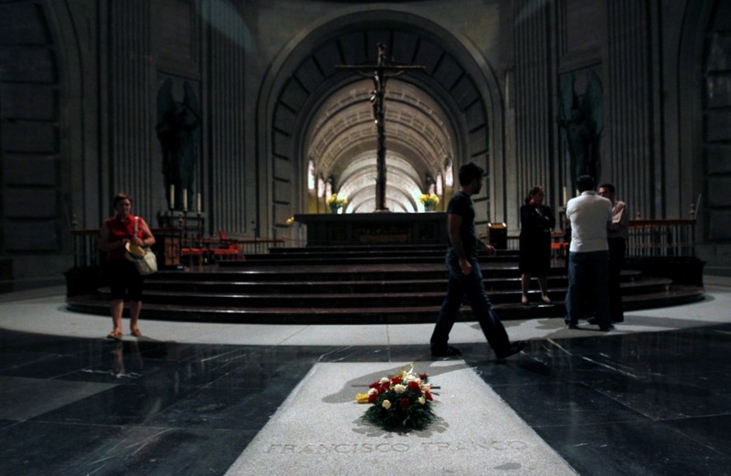 FILE PHOTO: Visitor walk past the tomb of dictator Francisco Franco is seen inside El Valle de los Caidos (The Valley of the Fallen), the giant mausoleum holding the remains of Franco, outside Madrid