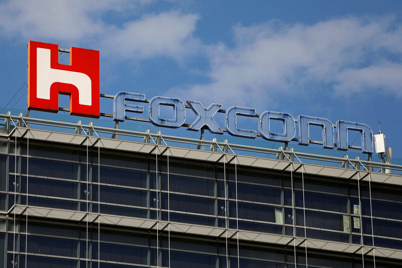 FILE PHOTO: The logo of Foxconn, the trading name of Hon Hai Precision Industry, is seen on top of the company's building in Taipei