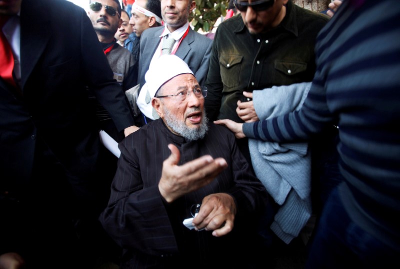 FILE PHOTO: Egyptian cleric Sheikh Yousef al-Qaradawi arrives to lead the Friday prayers in Tahrir Square in Cairo