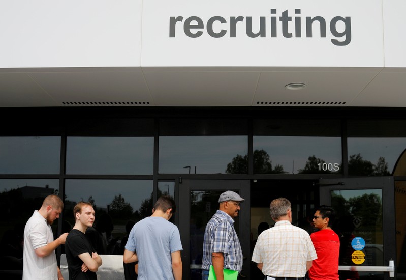 FILE PHOTO: Job seekers line up to apply during 