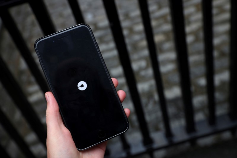 FILE PHOTO: The Uber logo is seen on mobile telephone in London