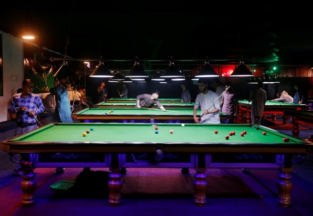 Afghan youth play snooker in Kabul