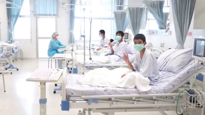 A screen grab shows boys rescued from the Thai cave wearing mask and resting in a hospital in Chiang Rai