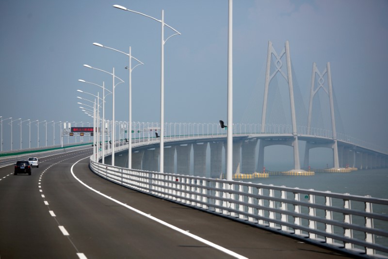 FILE PHOTO: Cars drive on a section of the Hong Kong-Zhuhai-Macau Bridge, to be opened in Zhuhai