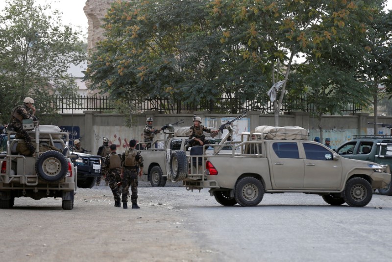 Afghan security forces arrive at the site of a blast in Kabul, Afghanistan