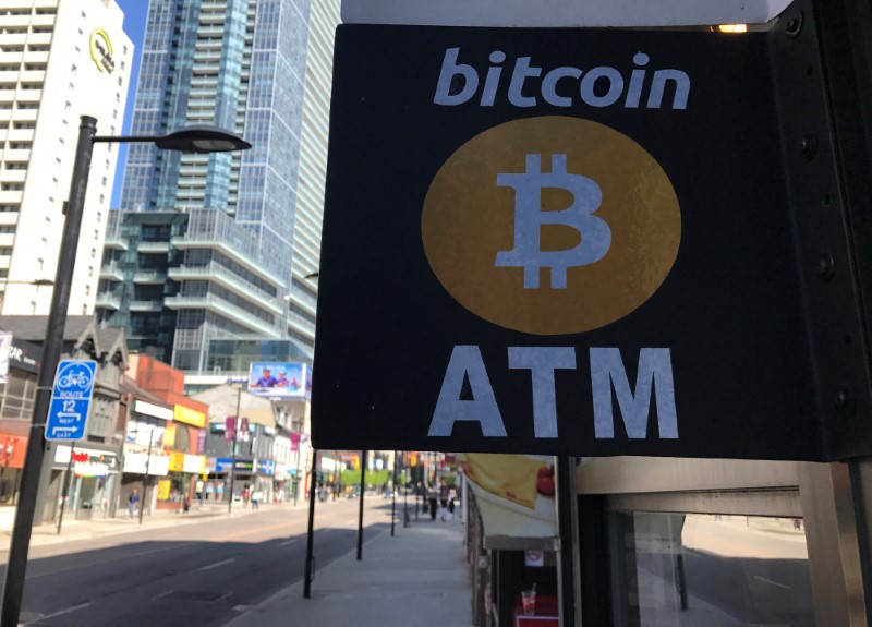 FILE PHOTO: A sign is seen outside a business where a Bitcoin ATM is located in Toronto