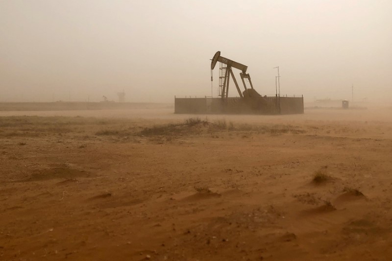 FILE PHOTO: Pump jack lifts oil out of well during sandstorm in Midland