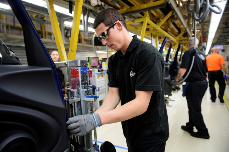 FILE PHOTO: Workers assemble cars at the plant for the Mini range of cars in Cowley, near Oxford