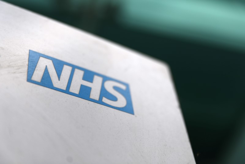FILE PHOTO: An NHS logo is displayed outside a hospital in London
