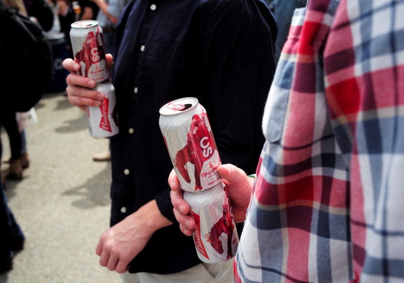 FILE PHOTO: People hold cans of beer during the Calgary Stampede in Calgary