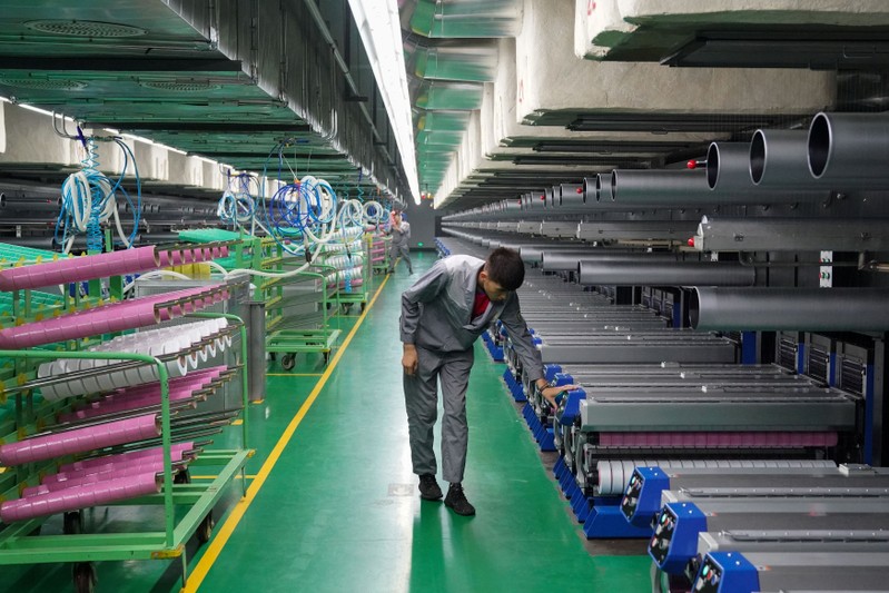 Worker inspects machines at a factory manufacturing spandex in an energy and chemical base in Yinchuan, Ningxia
