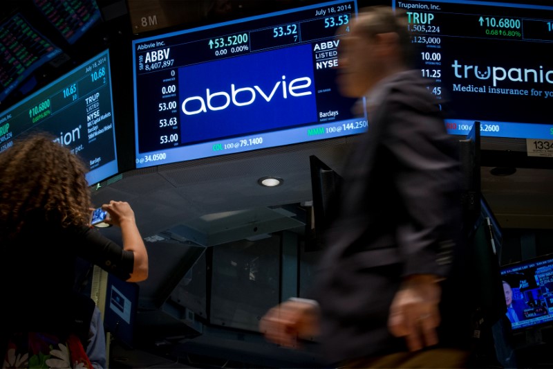 FILE PHOTO: A screen displays the share price for pharmaceutical maker AbbVie on the floor of the New York Stock Exchange