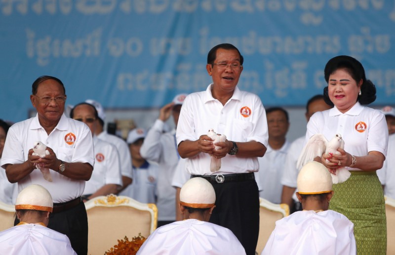 Honorary CPP president and President of the Cambodian National Assembly Heng Samrin, Cambodia's Prime Minister and president of the ruling Cambodian People's Party (CPP) Hun Sen and his wife Bun Rany prepare to release doves at an election campaign