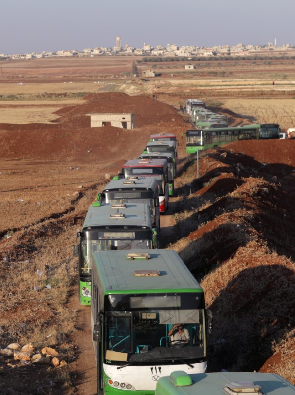 Ambulances and buses are seen near villages of al-Foua and Kefraya