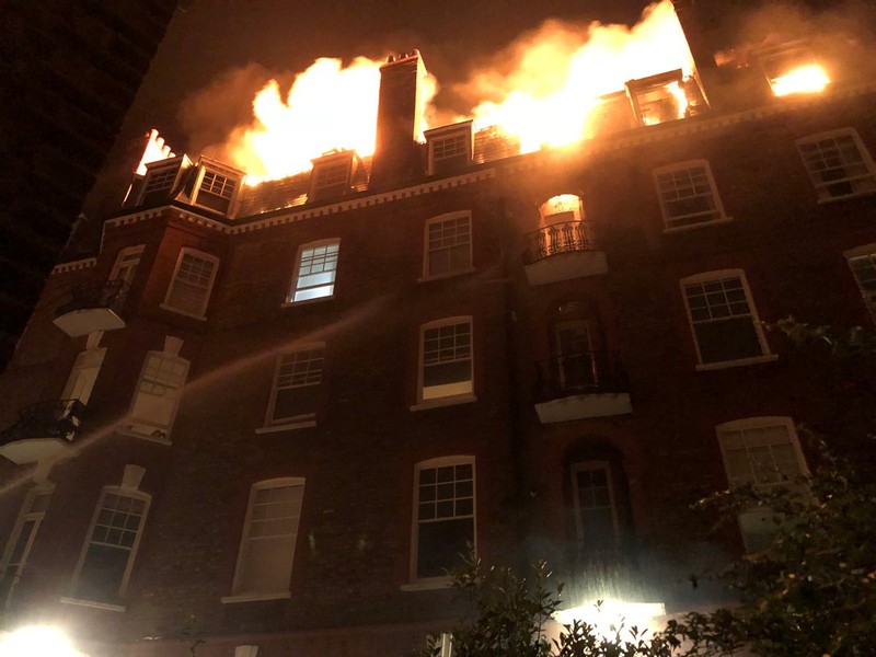 Firefighters tackle a blaze in a block of flats on fire in West Hampstead, London