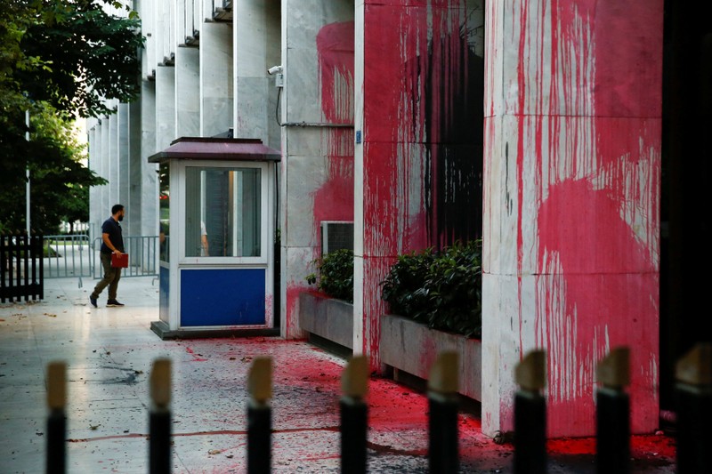 A man enters the Foreign Ministry building after a Greek self-proclaimed anarchists group threw red paint at the facade of the building, in Athens
