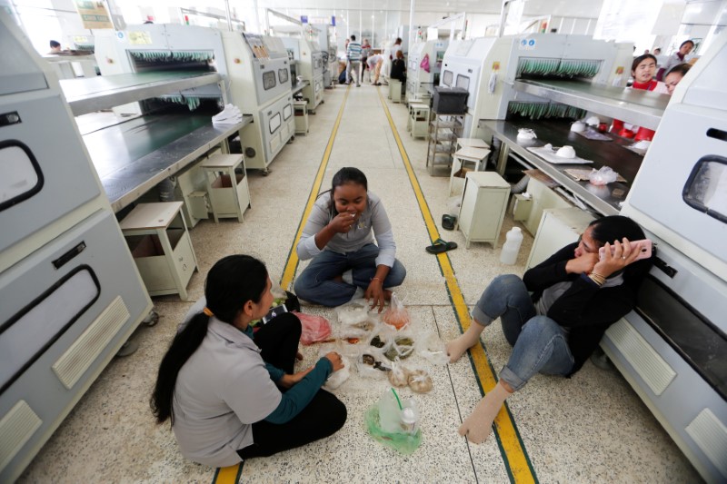 The Wider Image: Cambodian shoe maker has little time for politics